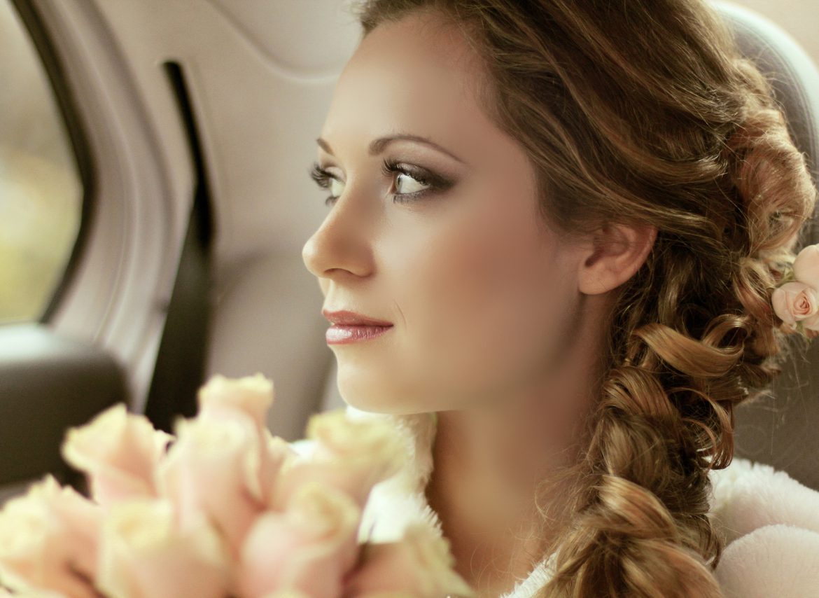 Beautiful bride woman portrait with bridal bouquet posing in her