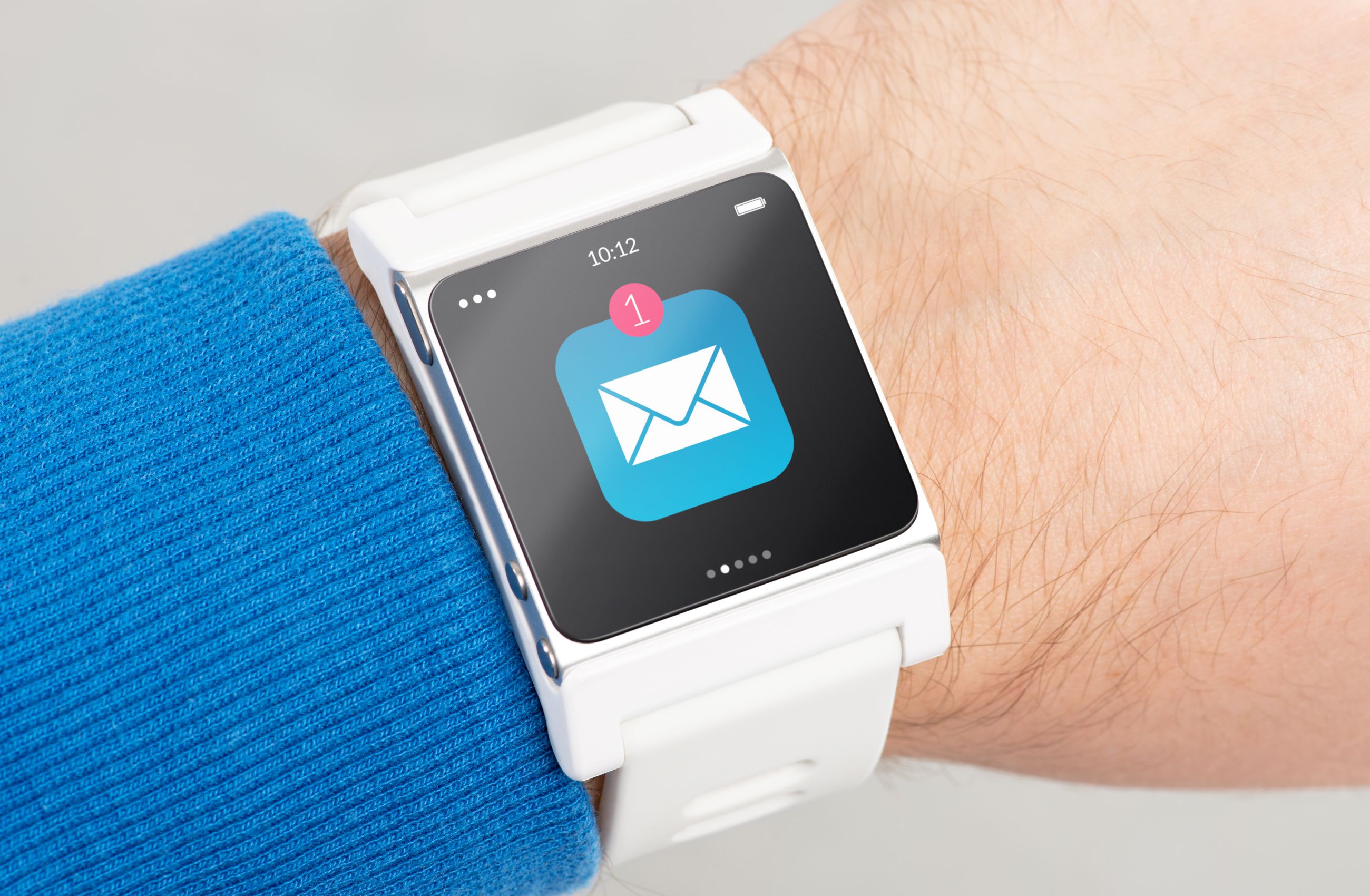 Close up white smart watch with unread message icon on the screen is on hand