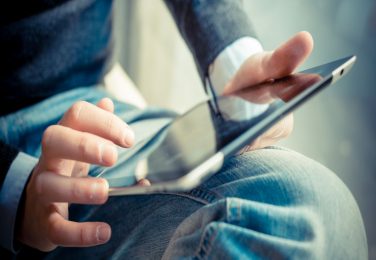 close up hands multitasking man using tablet, laptop and cellhpone connecting wifi