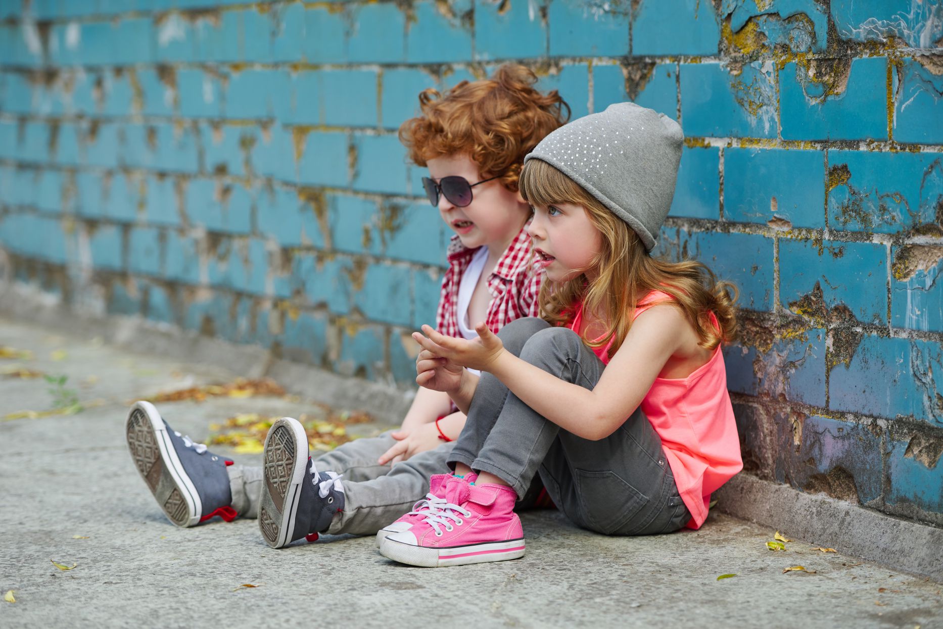 photo of two happy cute hipsters on the street