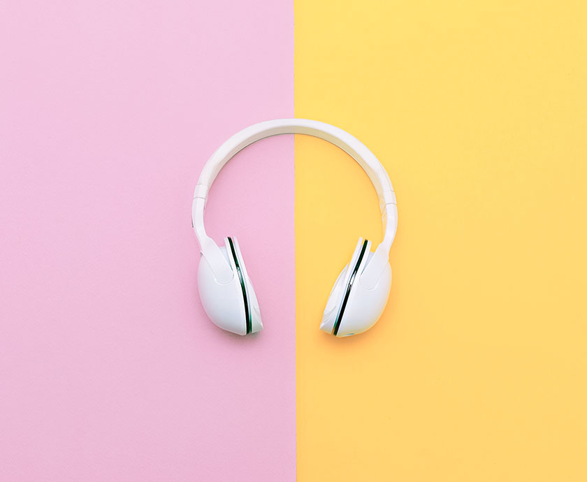 Fashion white headphones on vanilla background. Urban summer time