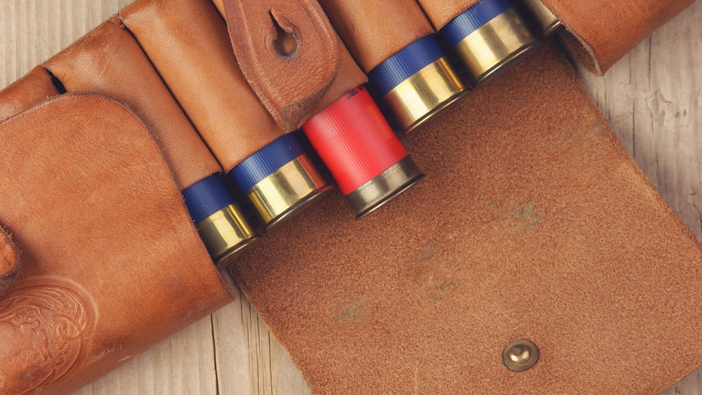 Old hunting cartridges and bandoleer on a wooden table