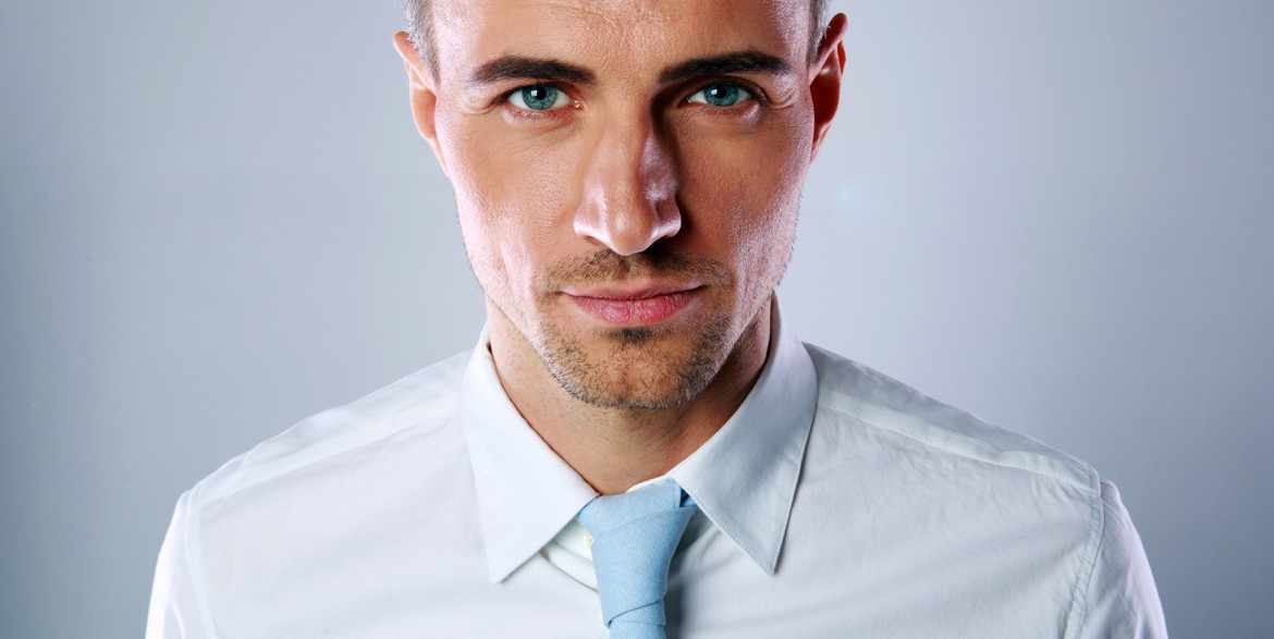 Portrait of a handsome businessman on gray background