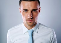 Portrait of a handsome businessman on gray background
