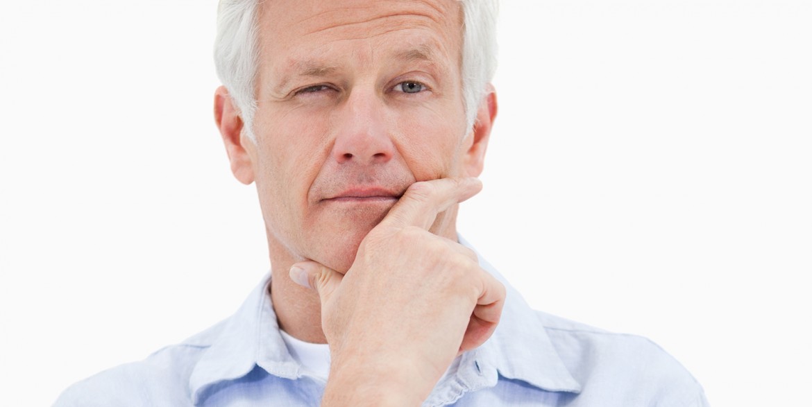 Portrait of a thoughtful mature man against a white background