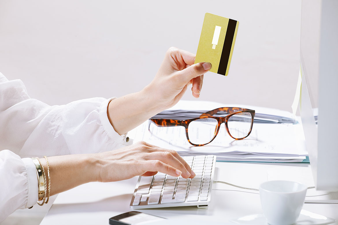 Young businesswoman with a credit card on hand.