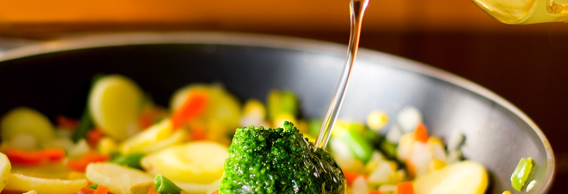 Black pan with different vegetables and oil