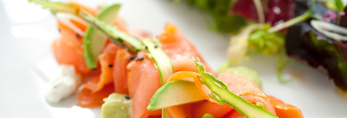 Close up of smoked salmon salad with green asparagus and avocado