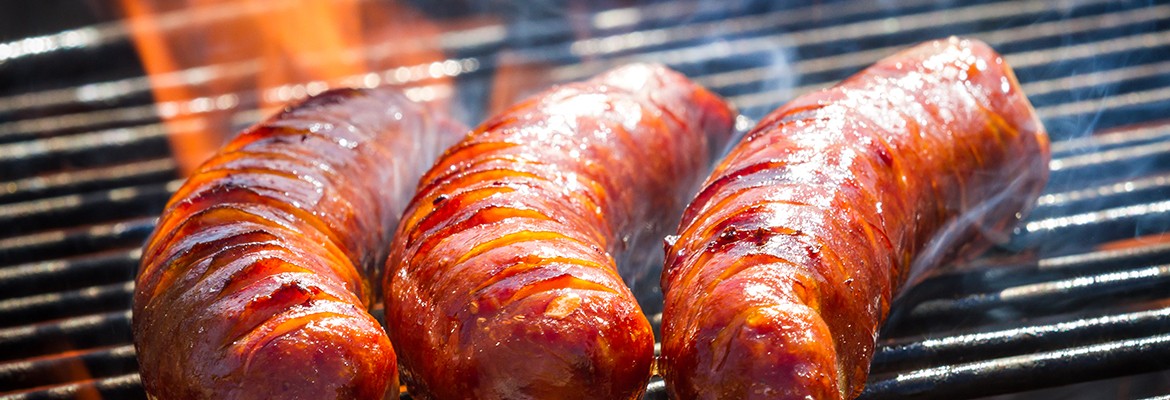 BBQ with fiery sausages on the grill
