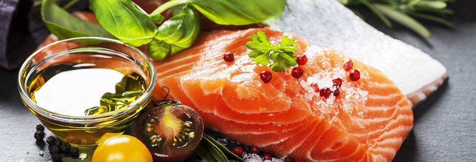 Delicious portion of fresh salmon fillet with aromatic herbs, spices and vegetables - healthy food, diet or cooking concept