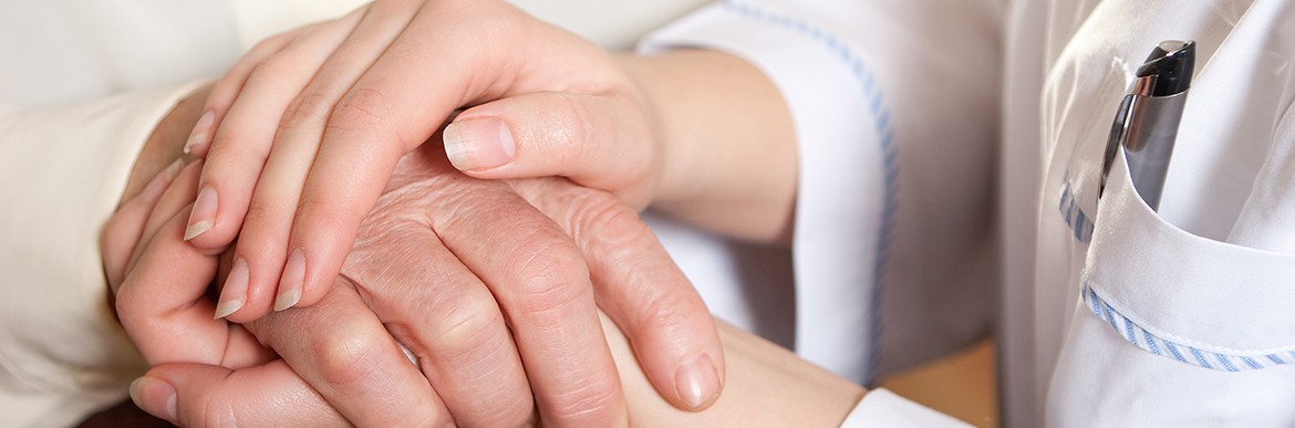 Helping hands: the nurse holds hands of the elderly female