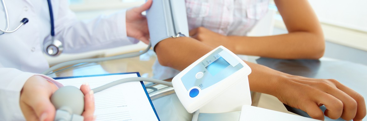 Close-up of tonometer by patient’s arm during blood pressure measuring at medical consultation