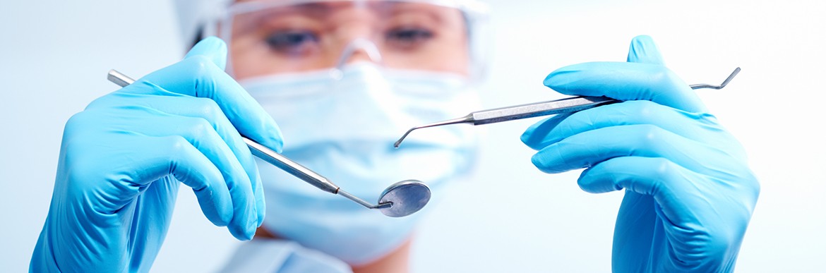 Image of dentist with medical tools