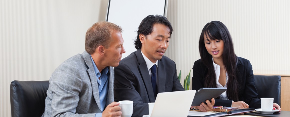 Business people using tablet in meeting