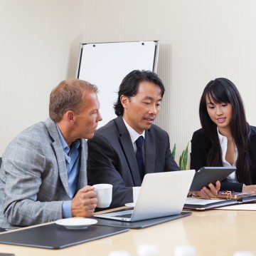Business people using tablet in meeting