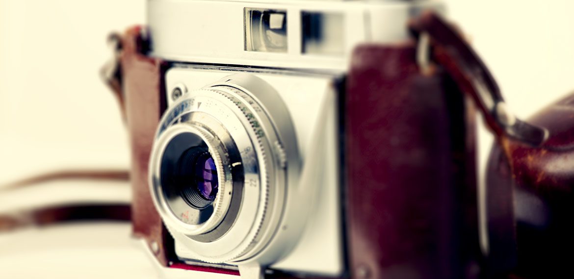 Old fashioned photography camera isolated over a white background