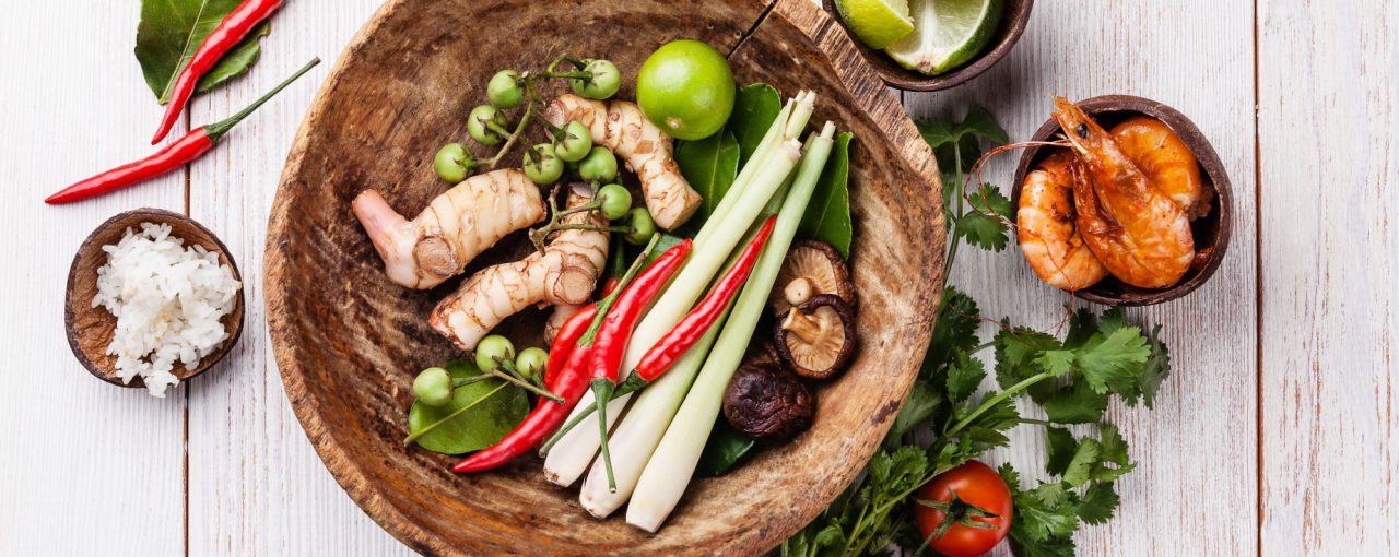 Ingredients for spicy Thai soup Tom Yam with Coconut milk, Chili pepper and Seafood on white wooden background
