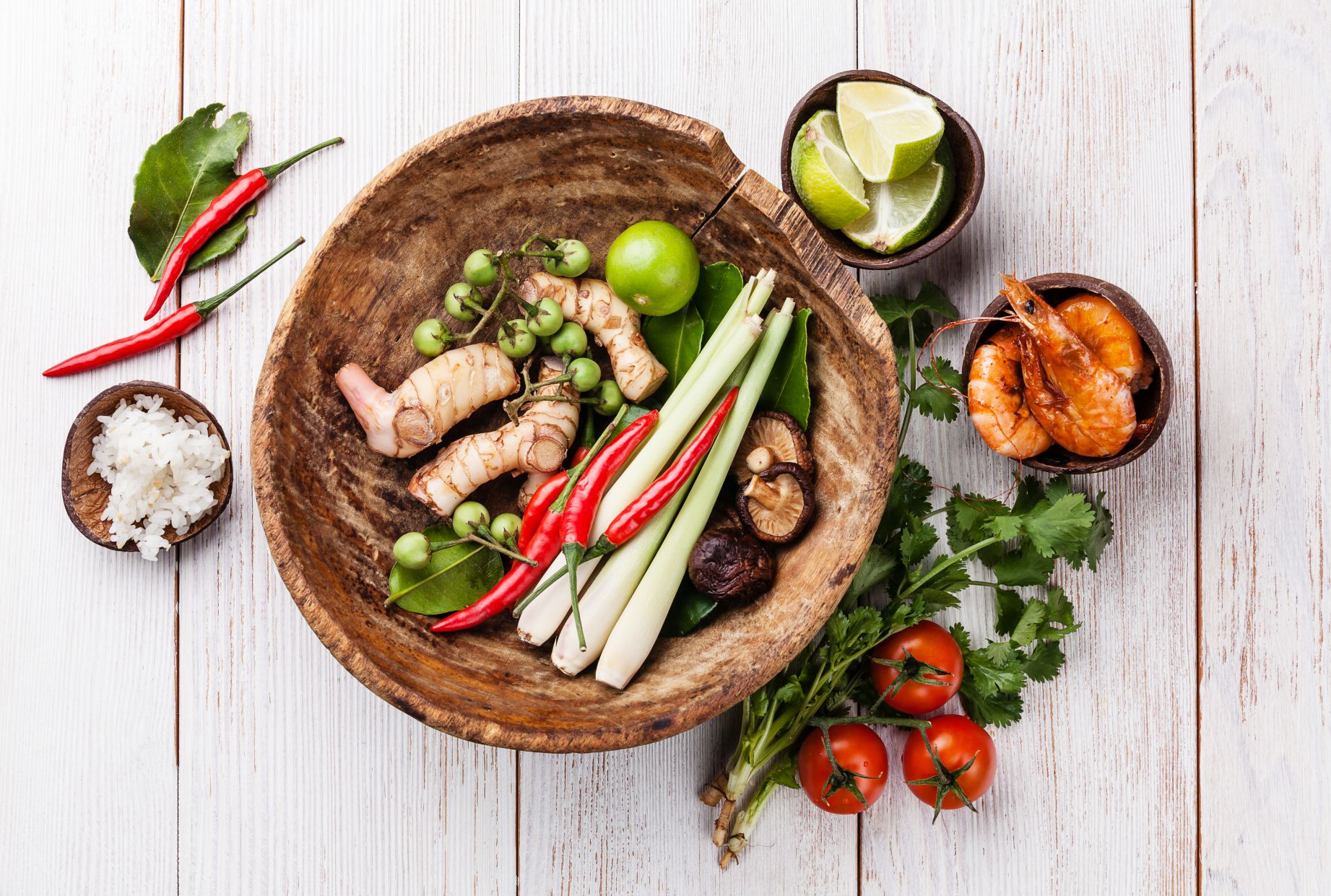 Ingredients for spicy Thai soup Tom Yam with Coconut milk, Chili pepper and Seafood on white wooden background