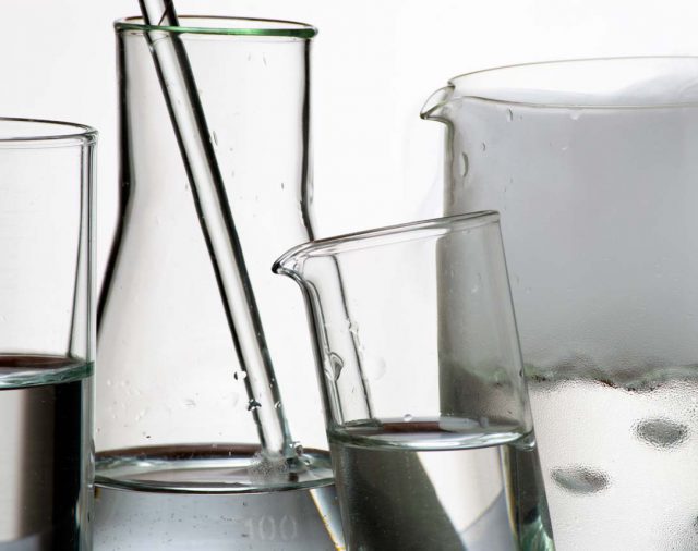 Laboratory glassware during experiment and vapors over liquid